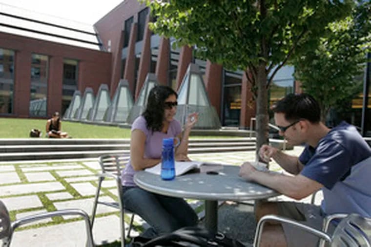 Wharton School student David Lebel, 27, lunches with his fiance, Eva Marwaha, at the Huntsman Hall courtyard. The 126-year-old school is part of the University of Pennsylvania.