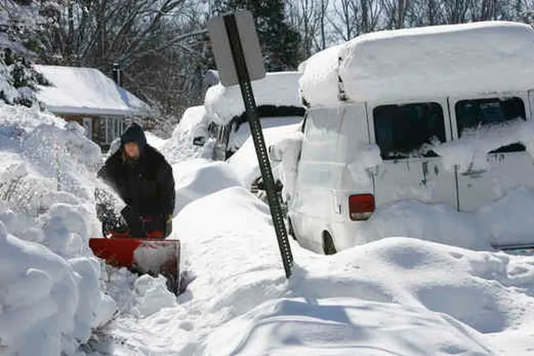 Danielle Faralli clears snow from the sidewalk at her home on Valley Road in Woodlyn, Delaware County, during the incredibly snowy February in 2010, a "strong" El Nino winter.