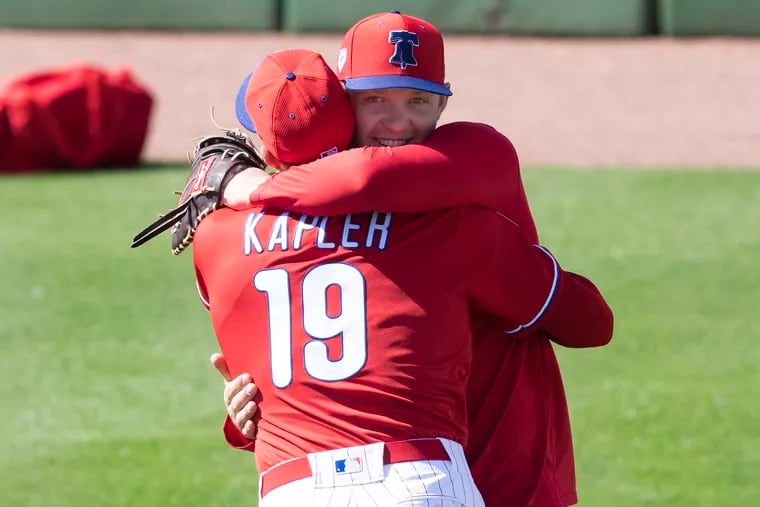 Rhys Hoskins hugs Phillies manager Gabe Kapler at spring training.