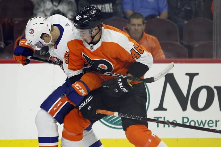 Mikhail Vorobyev, right, ties up the stick of the Islanders' Devon Toews in a preseason game. Vorobyev and Oskar Lindblom are two rookies on the Flyers' opening-night roster.