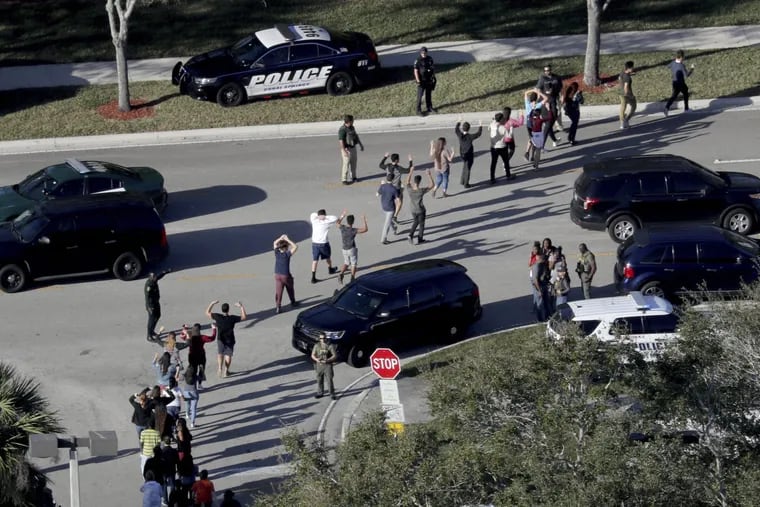 Students evacuate their high school in Parkland, Fla. on the day a gunman killed 17 people at the school.