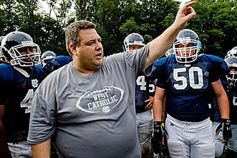 West Catholic coach Brian Fluck gives instructions to his players. (David M Warren/Staff file photo)
