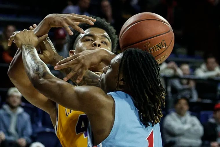 Roman Catholic Shareef Jackson tries for the loose ball with Father Judge Laquan Byrd during the 1st quarter of the Catholic League boys semifinals at the Palestra, Wednesday, February 21, 2024.