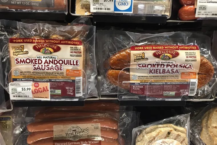 Packages of Wellshire sausages on a grocery-store shelf.
