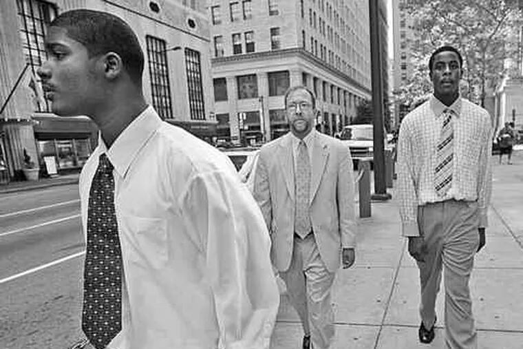 Nashir Fisher (left) and Ameer Best (right) with Best's attorney, Richard Brown, during trial in subway-beating death of Sean Conroy.