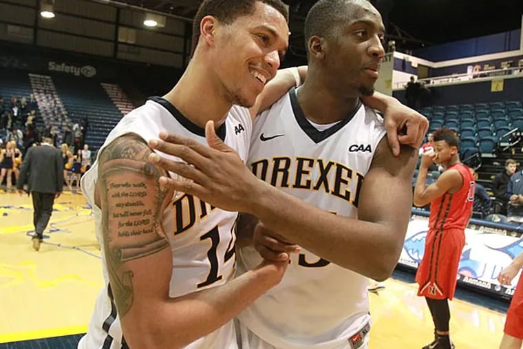 Damion Lee (left) is hugged by Mohamed Bah after. (Charles Fox/Staff Photographer)
