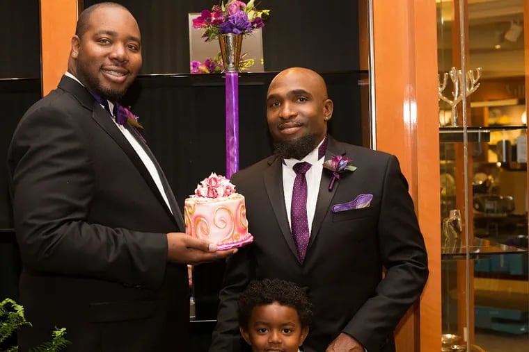 Jason Strong (left) and Anthony Henderson with their son, Marcelino. They were married in a Los Angeles-area Macy's. (Laura Palazzolo)