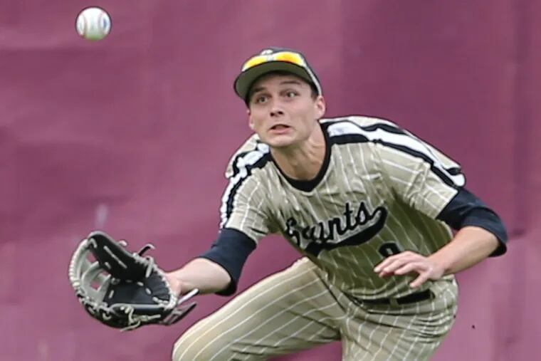 Neumann-Goretti’s Colin Eiser is about to snag a ball in center field.