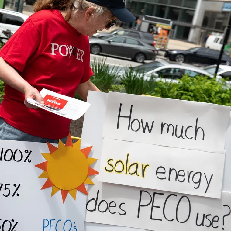 Volunteer Wendy Greenspan (center) hands out stickers and Wawa gift cards to participants during an engagement activity hosted by POWER Interfaith, a religious advocacy organization, to educate members of the public about their plans to encourage Peco to increase its use of renewable energy outside of City Hall on Wednesday, May 8, 2024. POWER Interfaith is one of the groups that testified at the Pennsylvania Public Utilities Commission hearings in April 2024, which will help decide how Peco procures its energy supply.