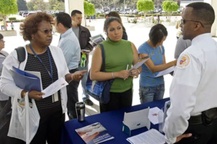 U.S. Secret Service Uniformed Police division representatives talk with attendees at a Los Angeles job fair hosted by the FBI.