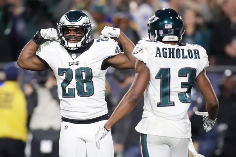Wendell Smallwood celebrates his third-quarter touchdown run with Nelson Agholor on Sunday in Los Angeles.