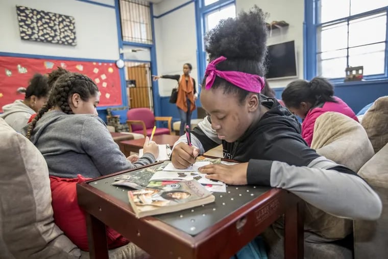 Nicole Gordon (center), 11, and other girls in the “Believe in Yourself” project at the East Falls Boys and Girls Club work on setting goals.