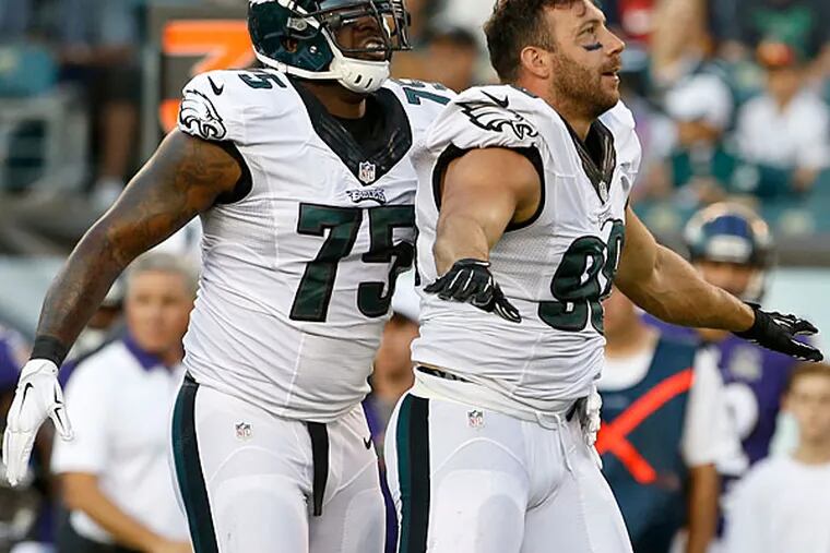 Connor Barwin celebrates a stop with teammate Vinny Curry against the Baltimore Ravens.