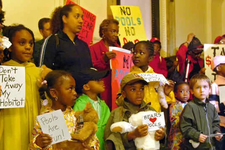 Before the Council meeting , children from the Montessori Genesis II School, holding signs and teddy bears, took part in a demonstration against the closing of some city pools.
