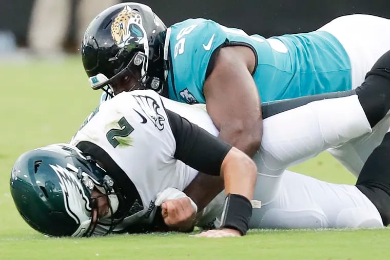 Eagles quarterback Cody Kessler getting taken to the ground by Jaguars defensive end Datone Jones during the first quarter.