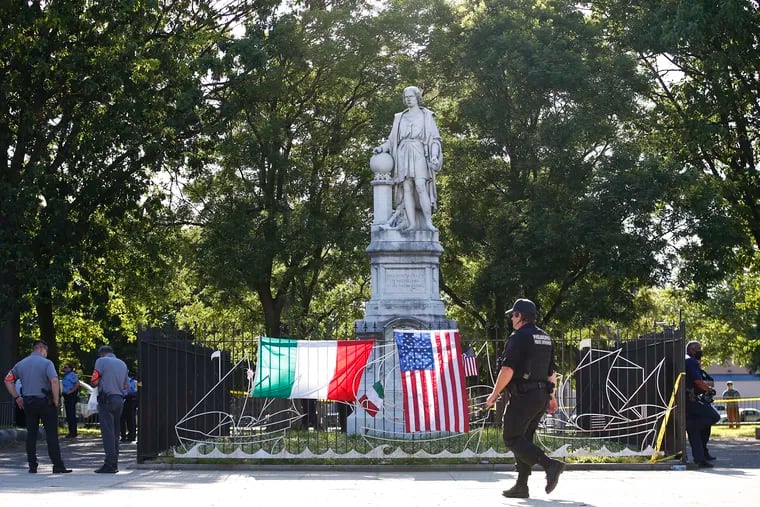Philadelphia Police stand around the Christopher Columbus statue at Marconi Plaza in South Philadelphia on Sunday.
