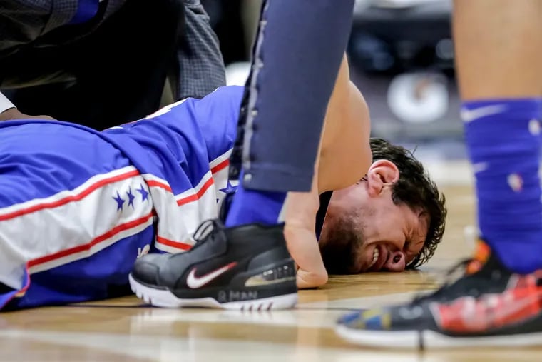 Boban Marjanovic winces in pain after being injured in the second half against New Orleans.