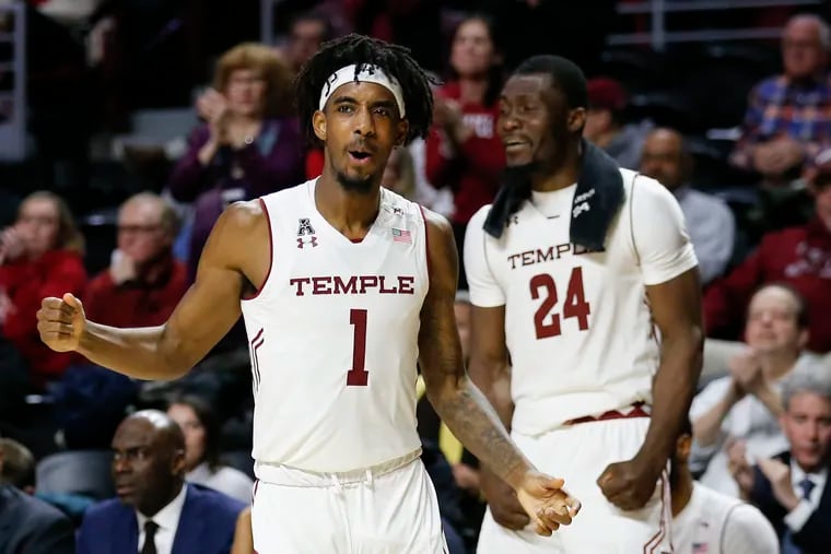 Temple guard Quinton Rose pumps his fist with teammate center Ernest Aflakpui after Temple stole the basketball against Memphis.