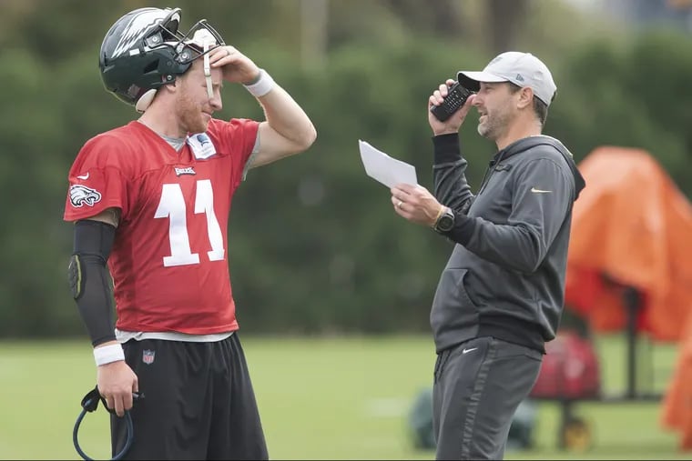 Eagles' quarterback Carson Wentz, left, talks to offensive coordinator, Mike Groh during practice at the NovaCare Complex on October 9, 2018 in Philadelphia, PA. JOSE F. MORENO / Staff Photographer