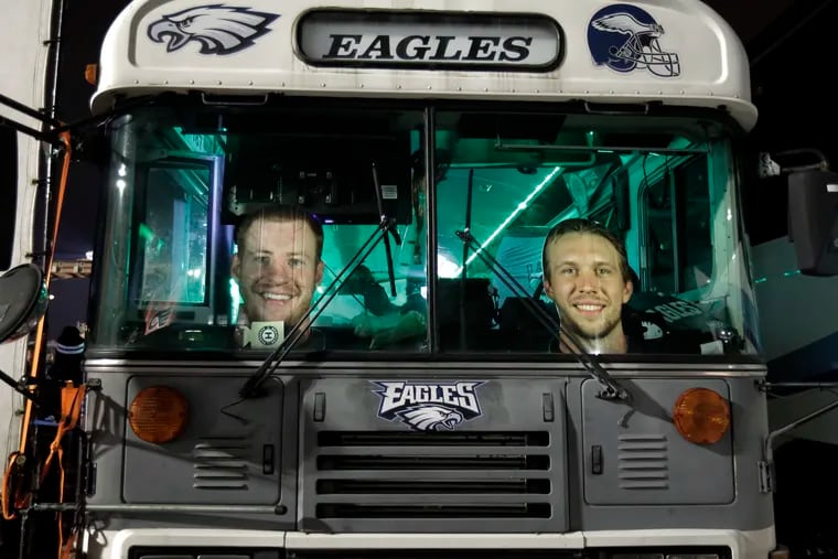 Photos of Nick Foles and Carson Wentz are displayed in the bus of an Eagles fan during the 2017 playoffs after Foles replaced the injured Wentz.