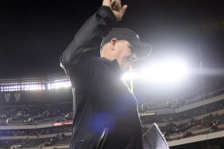 Chip Kelly raises his fist after beating the Chicago Bears, 54-11. (Yong Kim/Staff Photographer)
