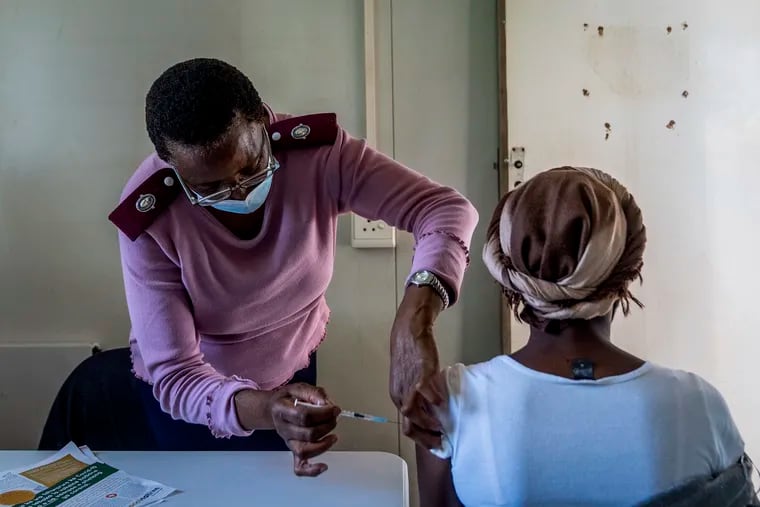 A woman is vaccinated against COVID-19 in Lawley, south of Johannesburg, South Africa, Wednesday, Dec. 1, 2021. Scientists say it could be weeks before they better understand how dangerous the omicron variant is. (AP Photo/ Shiraaz Mohamed)