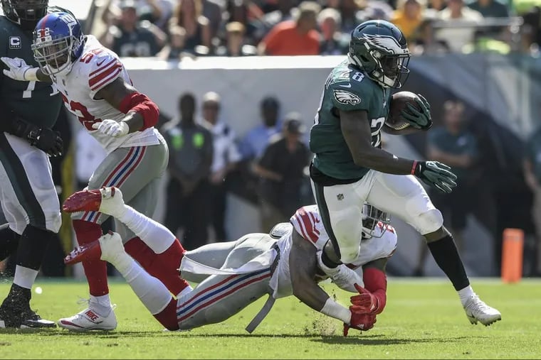 Eagles running back Wendell Smallwood fights off New York Giants safety Landon Collins in the Eagles’ 27-24 win over the Giants on Sunday.