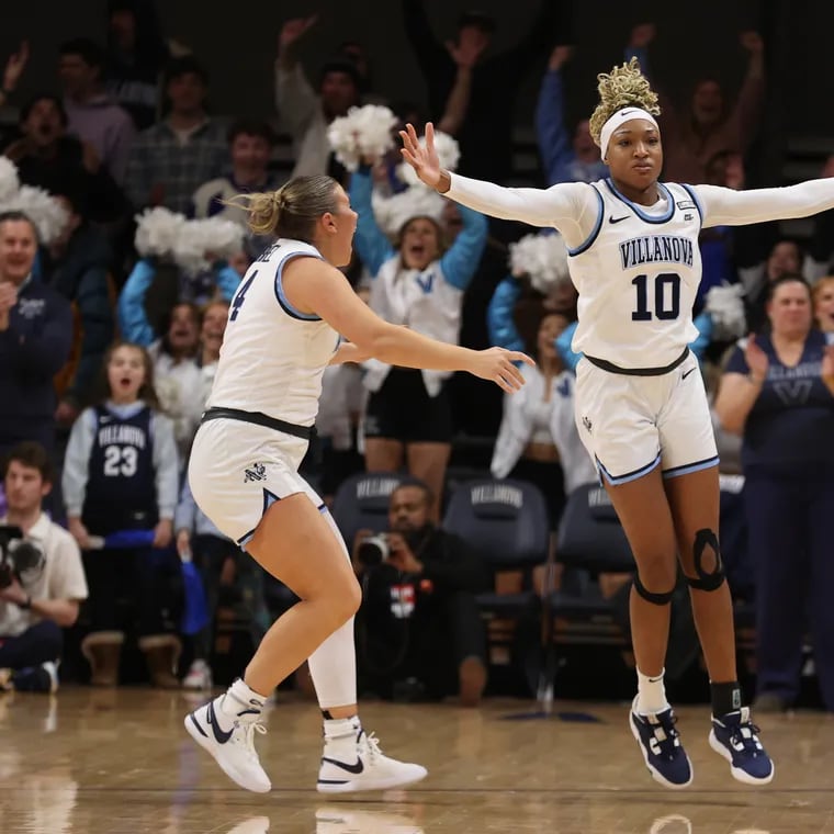 Christina Dalce (right) celebrates a win over Marquette with teammate Kaitlyn Orihel. Dalce, who was the team's second-leading scorer and led the Wildcats in rebounds and blocks, entered the transfer portal.