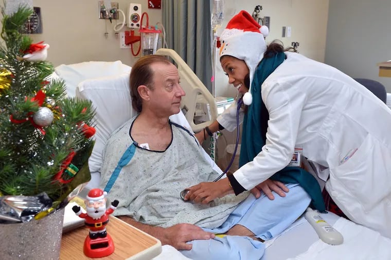 Dr. Loren Robinson checks on patient Kenneth Schultz in his room at Abington Health Lansdale Hospital on Christmas Day. December 25, 2015.