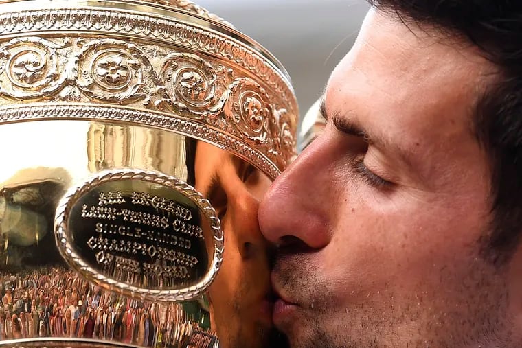 Serbia's Novak Djokovic kissing the trophy during the presentation after he defeated Switzerland's Roger Federer in the men's singles final at Wimbledon last year.