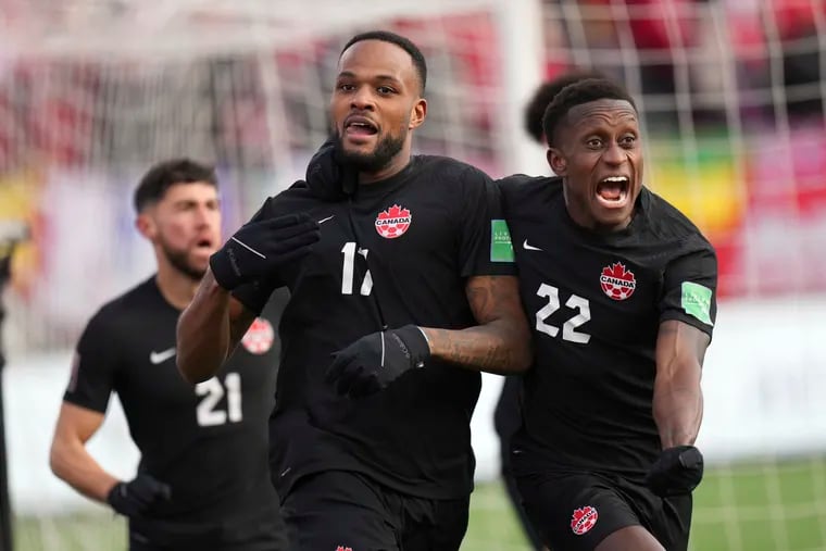 Cyle Larin (center) celebrates after scoring Canada's opening goal.