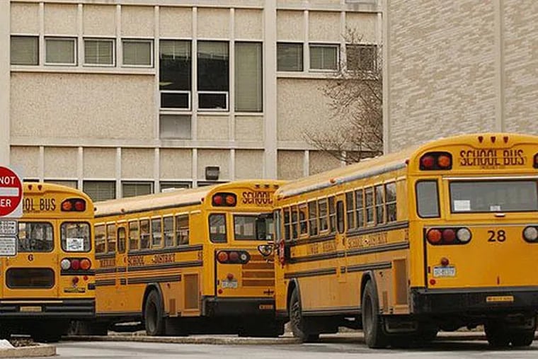 Buses line up at Lower Merion High School.  Two years after spending $210 million to rebuild its two high schools, setting off a redistricting battle, the Lower Merion School District is looking at expanding the schools. (Inquirer file art)