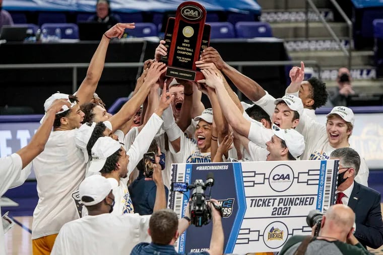 Drexel celebrates with the trophy after beating Elon in the CAA tournament championship game.