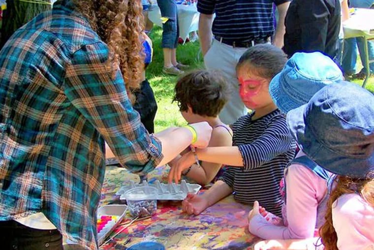 Children can have their faces painted at the Arts in the Park Festival in Elkins Park, one of many activities in addition to art and entertainment.