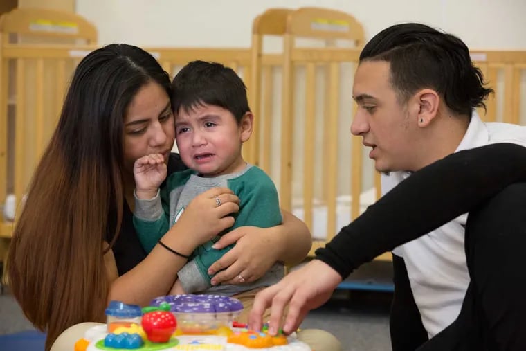 Daniela Sarabio, 18, left, comforts their 2 1/2-year-old son Kenay Camuy, center, with Leafar Camuy, 17, right, at the DCF Regional School, January 9, 2017. Camuy and Sarabio are particpants in a national program called the Period of PURPLE Crying.