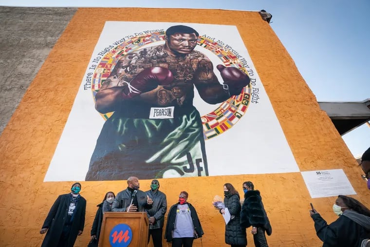 Joe Frazier Jr. speaks at the podium as Mural Arts Philadelphia dedicates a new mural to honor Philadelphia world champion boxer Smokin' Joe Frazier, at 1302 W. Allegheny Ave, in Philadelphia, March 8, 2021, on the 50th Anniversary of the 'Fight of the Century.'