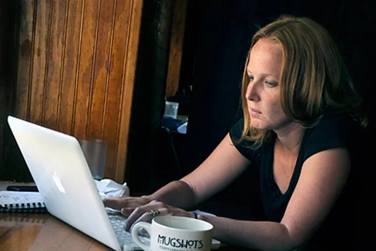Author Carrie Hagen at work in a coffeehouse near home. &quot;We Is Got Him,&quot; her first book, focuses on the 19th-century abduction of a Germantown boy. (Tom Gralish / Staff Photographer)