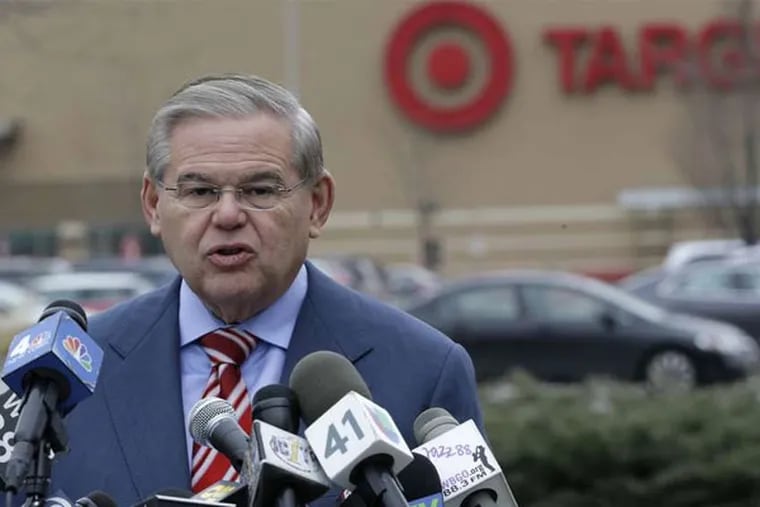 U.S. Sen. Robert Menendez (D., N.J.) speaks outside a Target store in Jersey City. He said he wants the Federal Trade Commission to see if more legislative action is needed on data theft. (Julio Cortez / Associated Press)