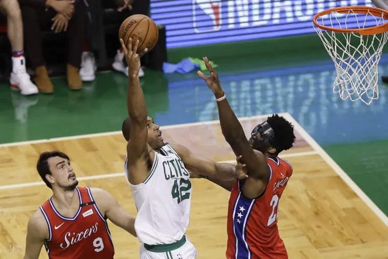 Celtics forward Al Horford shoots over the Sixers’ Joel Embiid and Dario Saric during Philadelphia’s Game 1 loss on Monday.