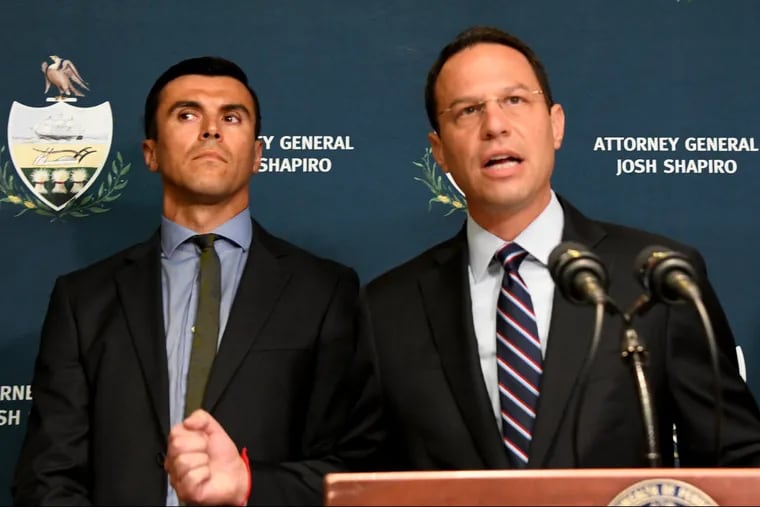 Pa. State Attorney General Josh Shapiro talks while "Josh," to the left, stands during the press conference at the Westmoreland County Courthouse, Tuesday July 31, 2018. Victim "Josh" was abused by Rev. John Sweeney, a Roman Catholic priest in the Diocese of Greensburg, in 1992.