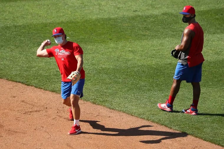 Scott Kingery and Jean Segura were among five Phillies who practiced while wearing masks Sunday at Citizens Bank Park.