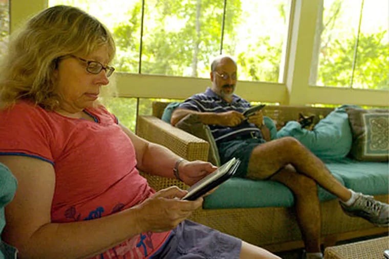Faith Paulsen and her husband Barton Sacks read their Kindles in their East Norrinton home. (Ron Tarver / Staff Photographer)