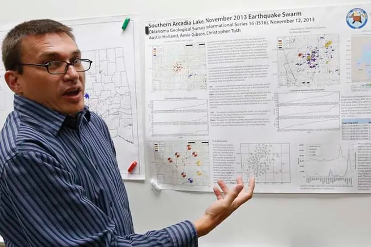 Austin Holland, research seismologist at the Oklahoma Geological Survey, gestures to a chart of Oklahoma earthquakes as he talks about recent earthquake activity at his offices at the University of Oklahoma in Norman, Okla., Thursday, June 26, 2014. Holland said the agency is closely monitoring the area's seismic activity to determine whether the earthquakes are a natural phenomenon or are man-made. (AP Photo/Sue Ogrocki)