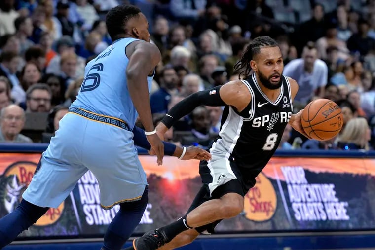 Spurs guard Patty Mills drives past Grizzlies guard Shelvin Mack in 2019. Will Mills become a Sixer?
