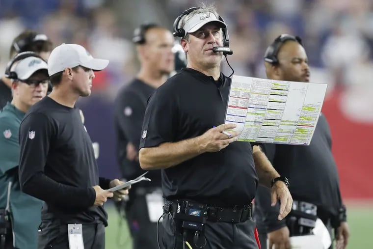 Eagles Head Coach Doug Pederson holds-up his play chart against the New England Patriots in the third-quarter during a preseason game at Gillette Stadium in Foxborough, MA on Thursday, August 16, 2018. YONG KIM / Staff Photographer