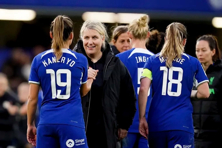 Emma Hayes (second from left) with her players after Chelsea's win over Liverpool on Saturday.
