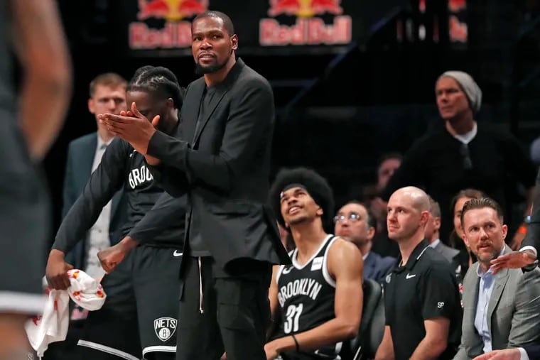 Brooklyn Nets forward Kevin Durant, shown clapping his hands during a game, is one of four Brooklyn Nets players to test positive for the coronavirus.