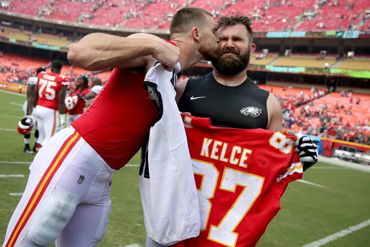 Chiefs’ tight end Travis Kelce plants a kiss on his brother, Eagles’ center Jason Kelce (right) as they exchange jerseys after their game in September of last season.Travis scored in the fourth quarter, going airborne into the end zone in their 27-20 win over the Eagles.