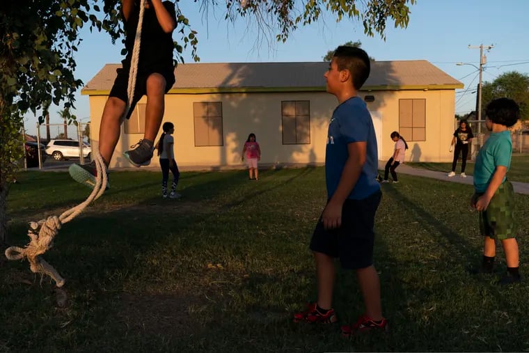 Children play in the yard of a community boxing club in August in Somerton, Ariz.