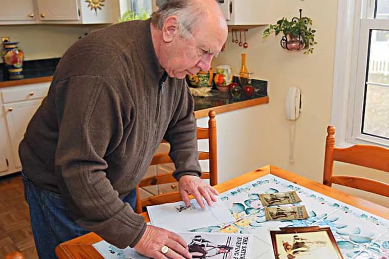 Robert Bazin of Cherry Hill, a retired FBI special agent, is looking copy pictures of stolen paint at his home.( AKIRA SUWA  /  Staff Photographer ) 

Robert Bazin of Cherry Hill, a retired FBI special agent, is on the hunt for an original Norman Rockwell that was stolen from a Cherry Hill home in 1976.